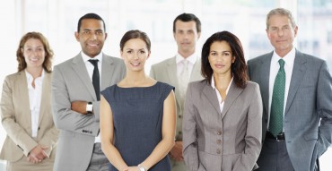 Group of successful business people standing together at office